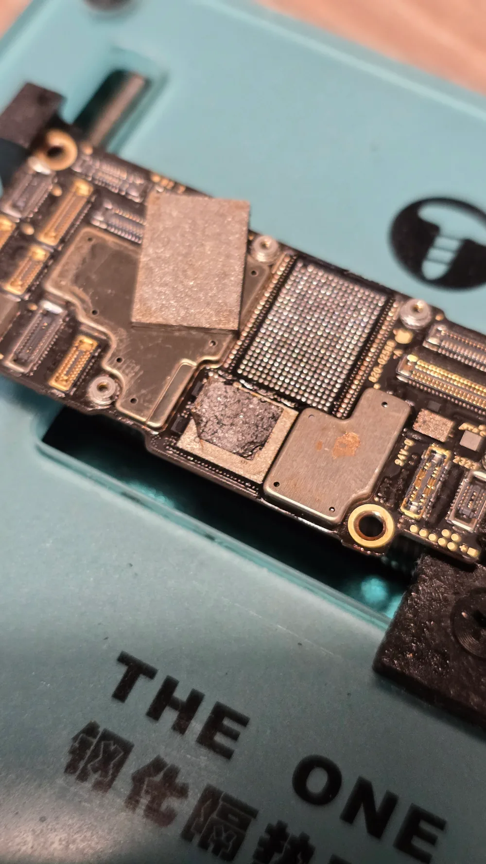 iPhone NAND flash chip removed from the logic board for chip-off data recovery at the Phone Studio bench in Courtice