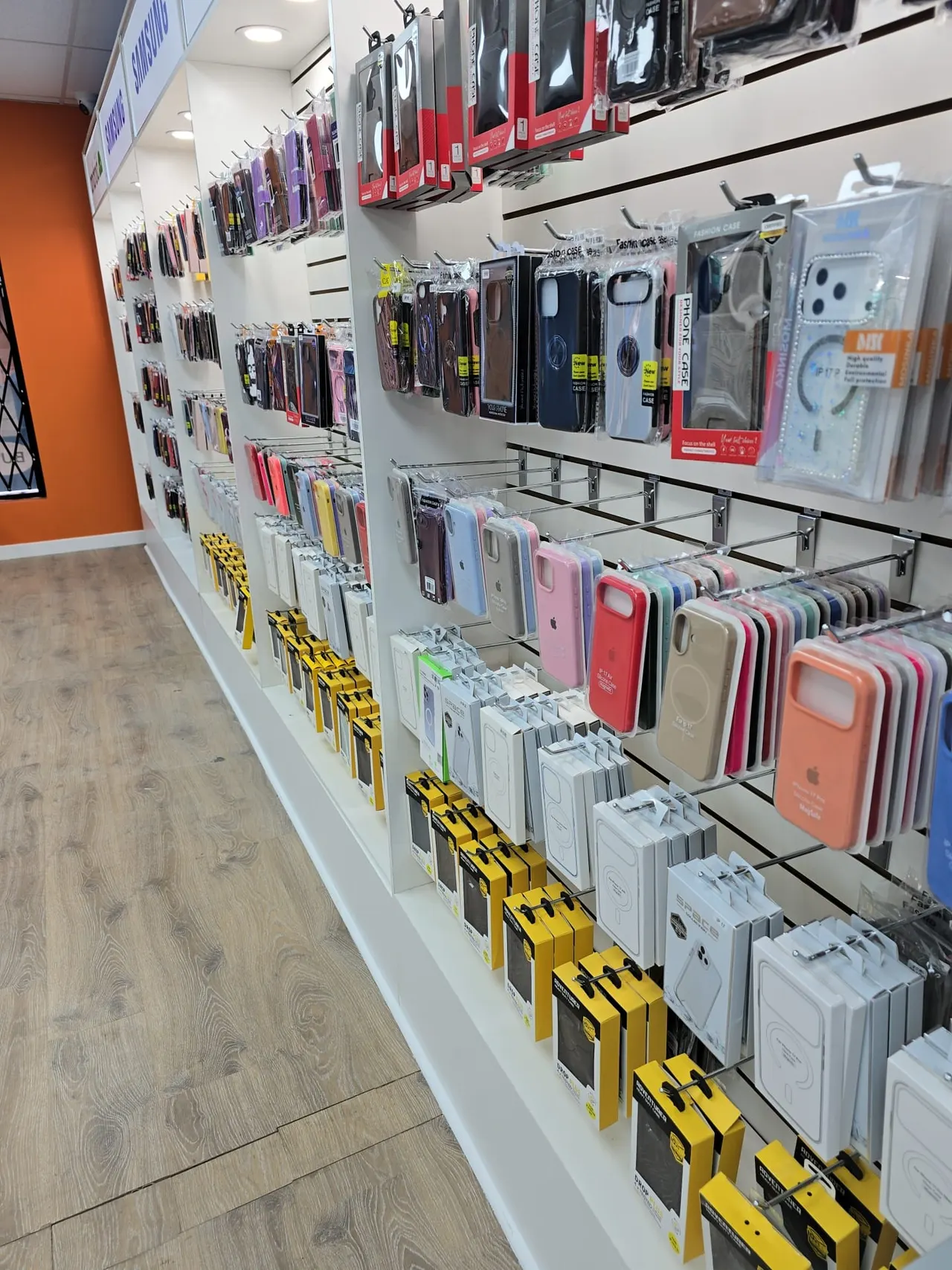 Wall of phone cases, screen protectors and accessories on display at the Phone Studio shop in Courtice.