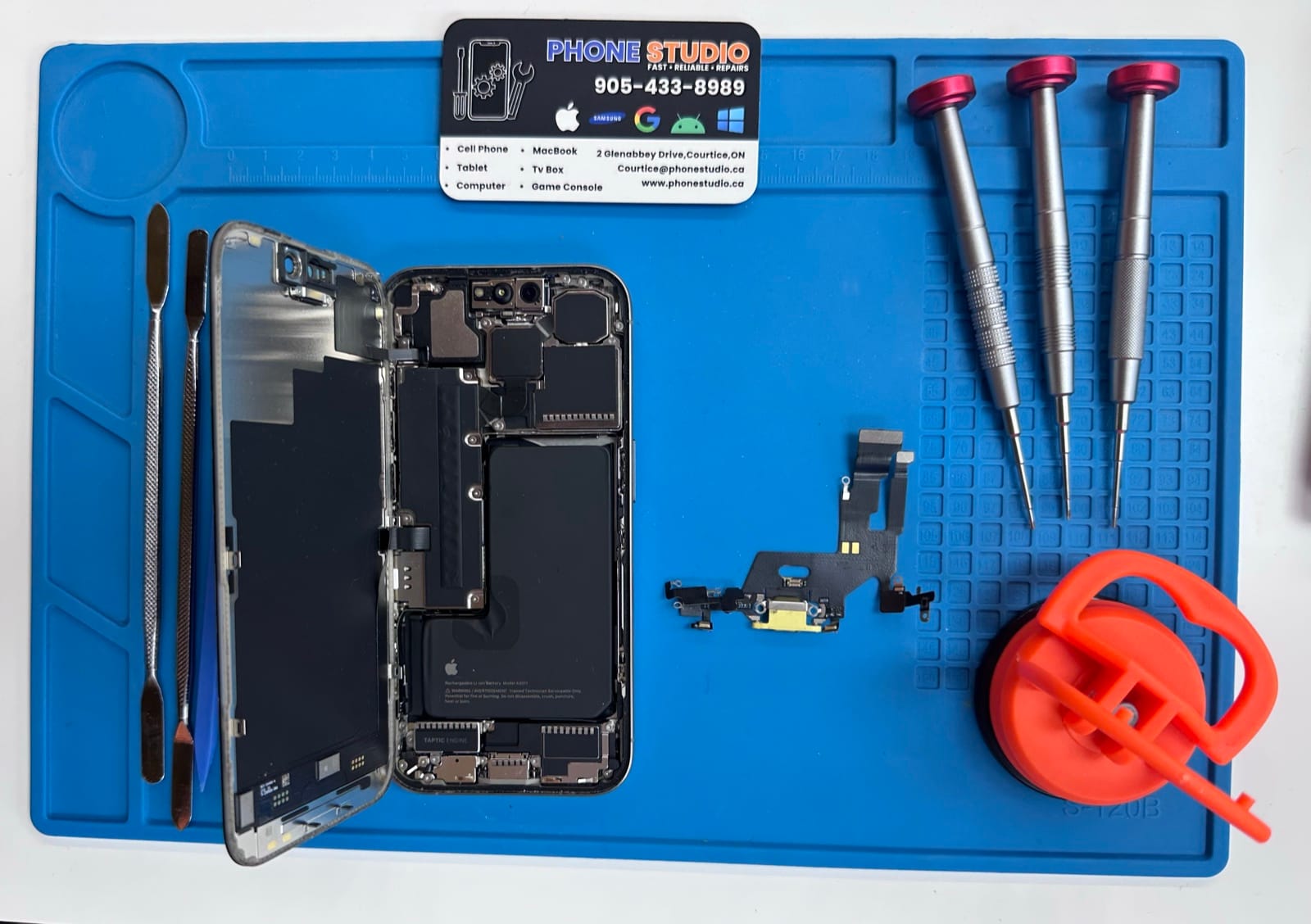 Charging port repair on the Phone Studio bench in Courtice