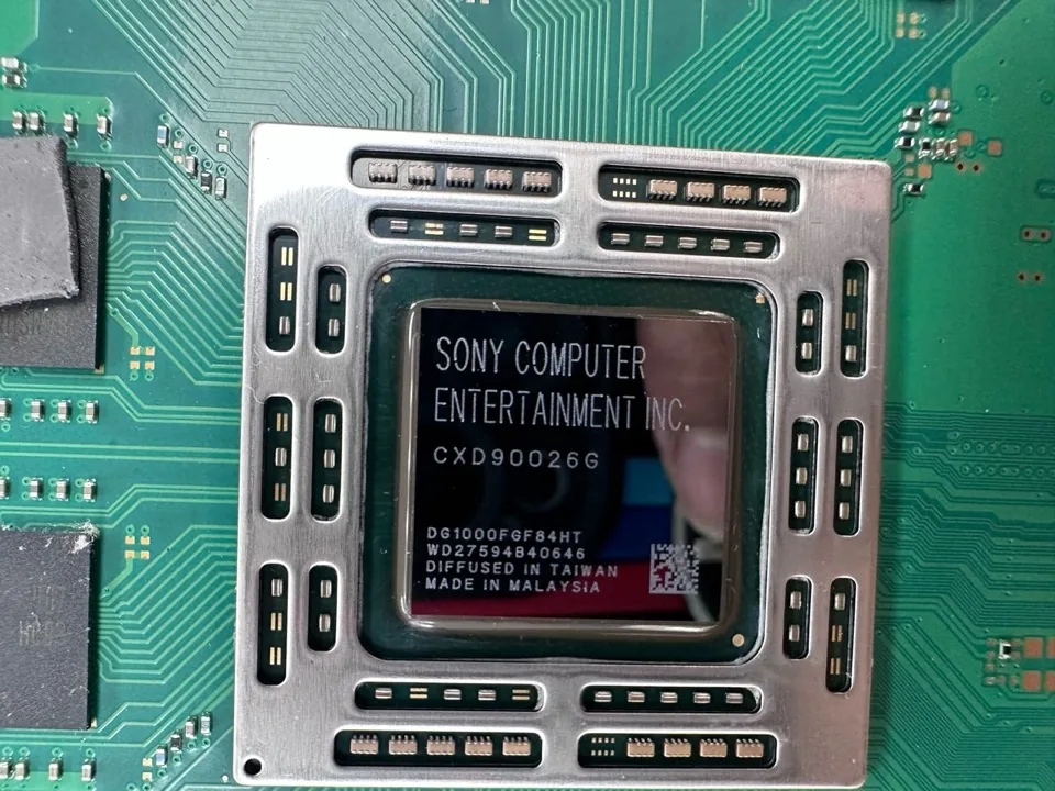 Bare PS4 APU chip with its Sony label visible and no thermal paste, on the Phone Studio bench in Courtice