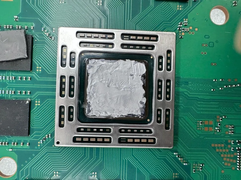 PS4 APU die coated edge to edge in thick gray thermal paste at Phone Studio in Courtice
