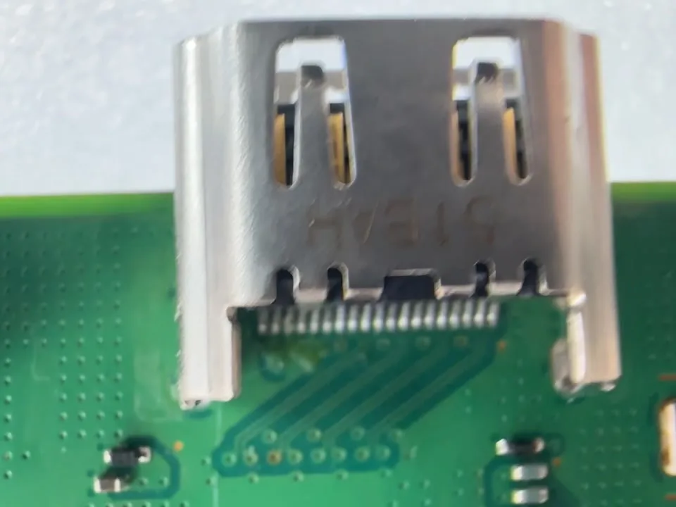 Close-up of a new HDMI port's solder joints on a PS4 circuit board at Phone Studio in Courtice